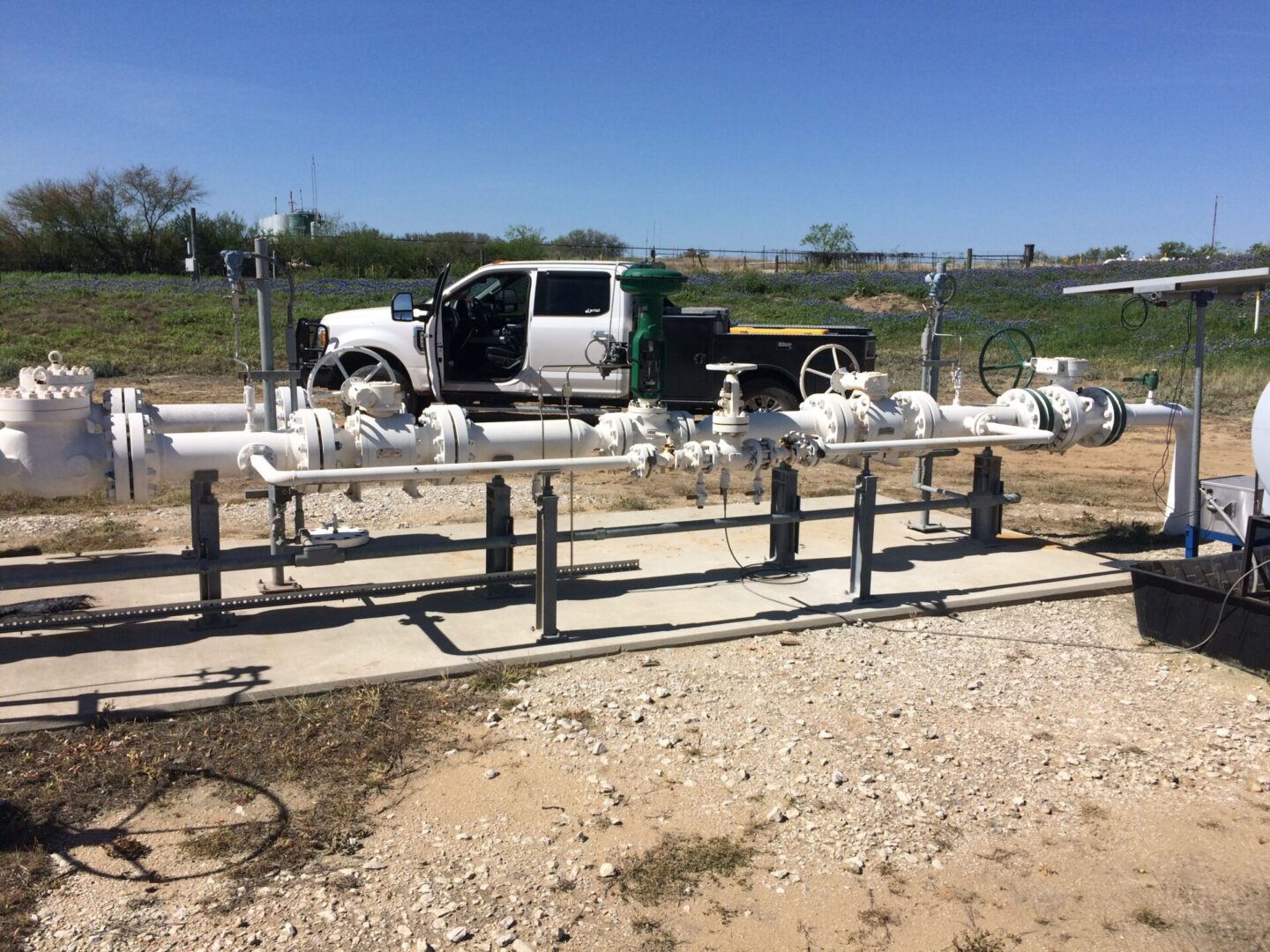 A truck parked in front of gas lines.