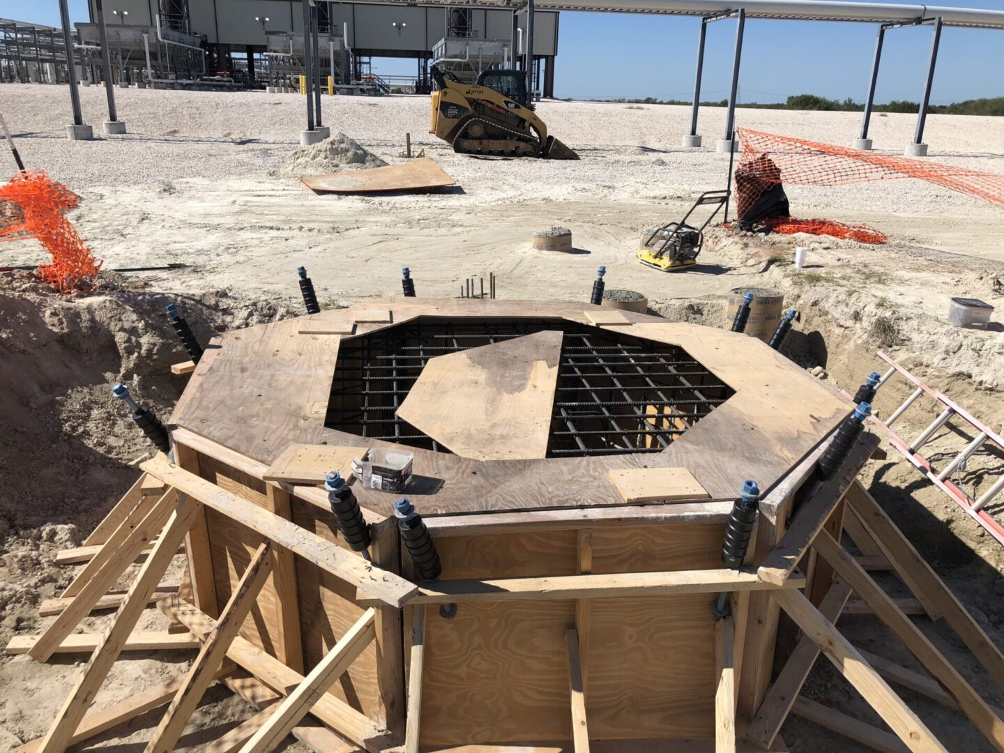 A large concrete structure sitting on top of a sandy beach.