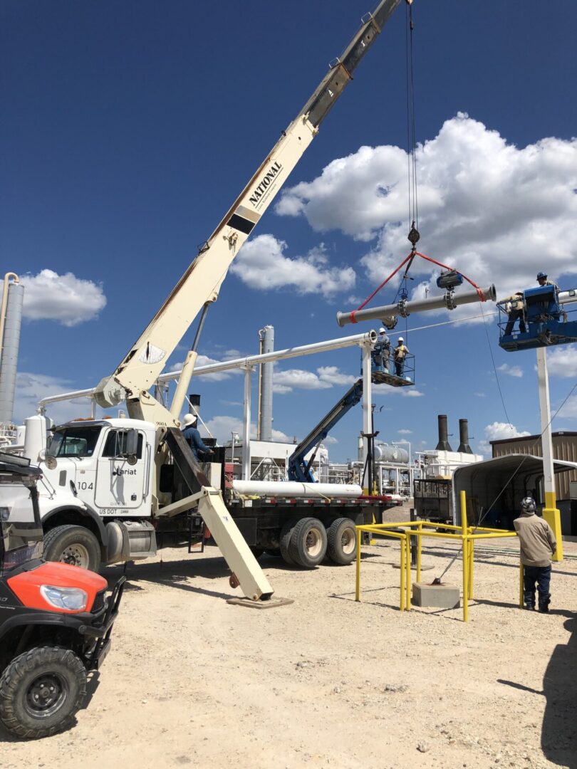 A crane is being used to lift a power pole.